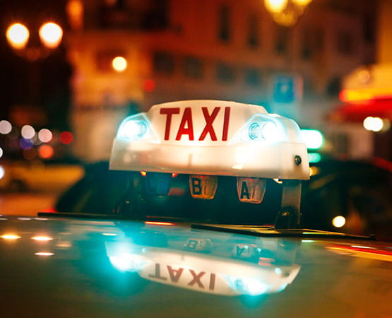 A taxi in a street at night