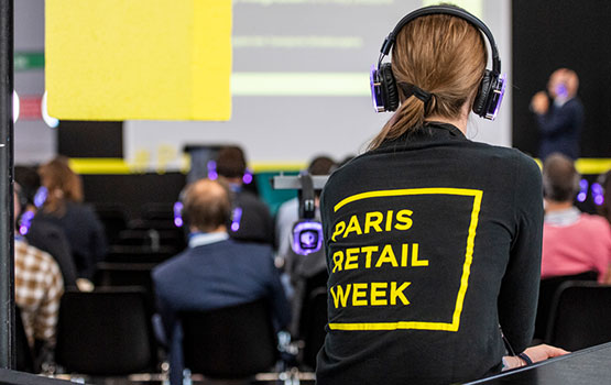 Woman wearing a jumper with the Paris Retail Week logo